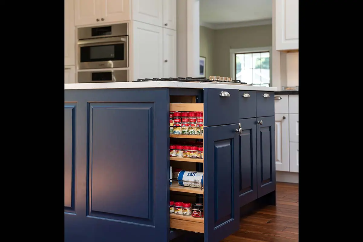 blue cabinets with pullout spice rack