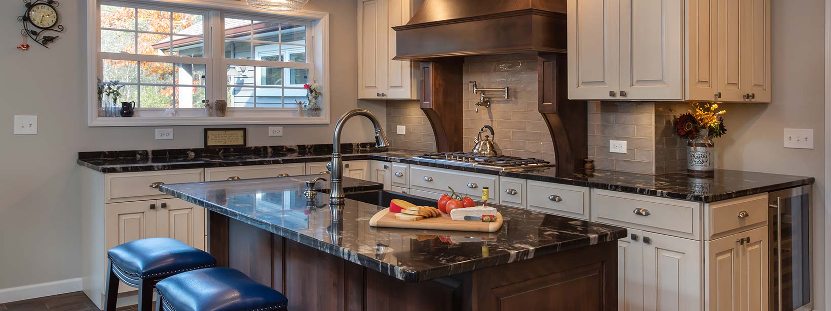 Custom painted and stained wood cabinets in kitchen