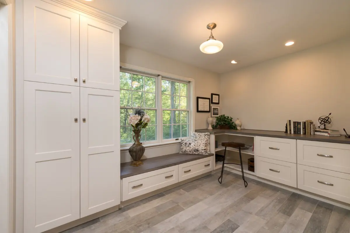 White cabinets with black countertops in living room.